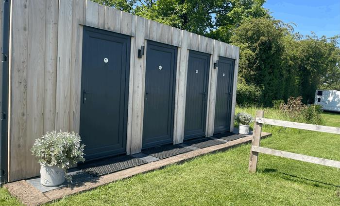 Top field shower and toilet block with beautiful plants welcoming guests and a wilding area to encourage the bees